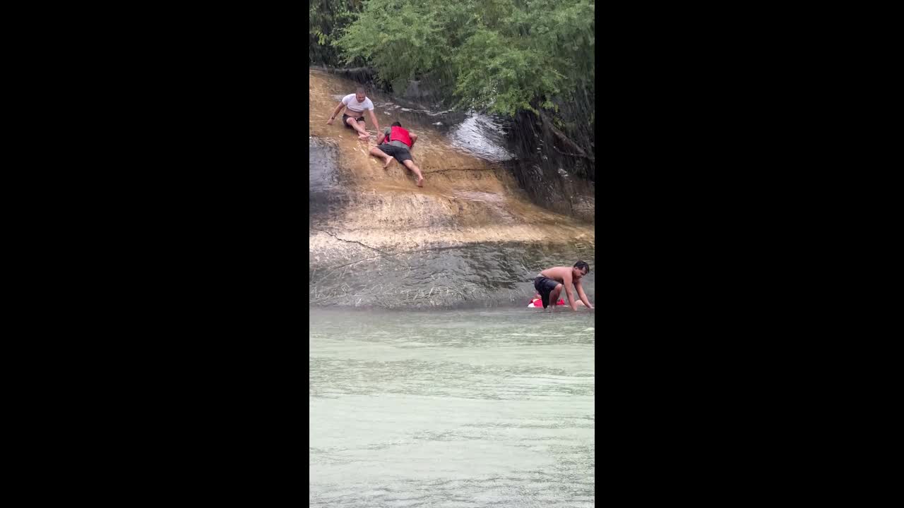 Tourist slips on wet rockface and plunges into water