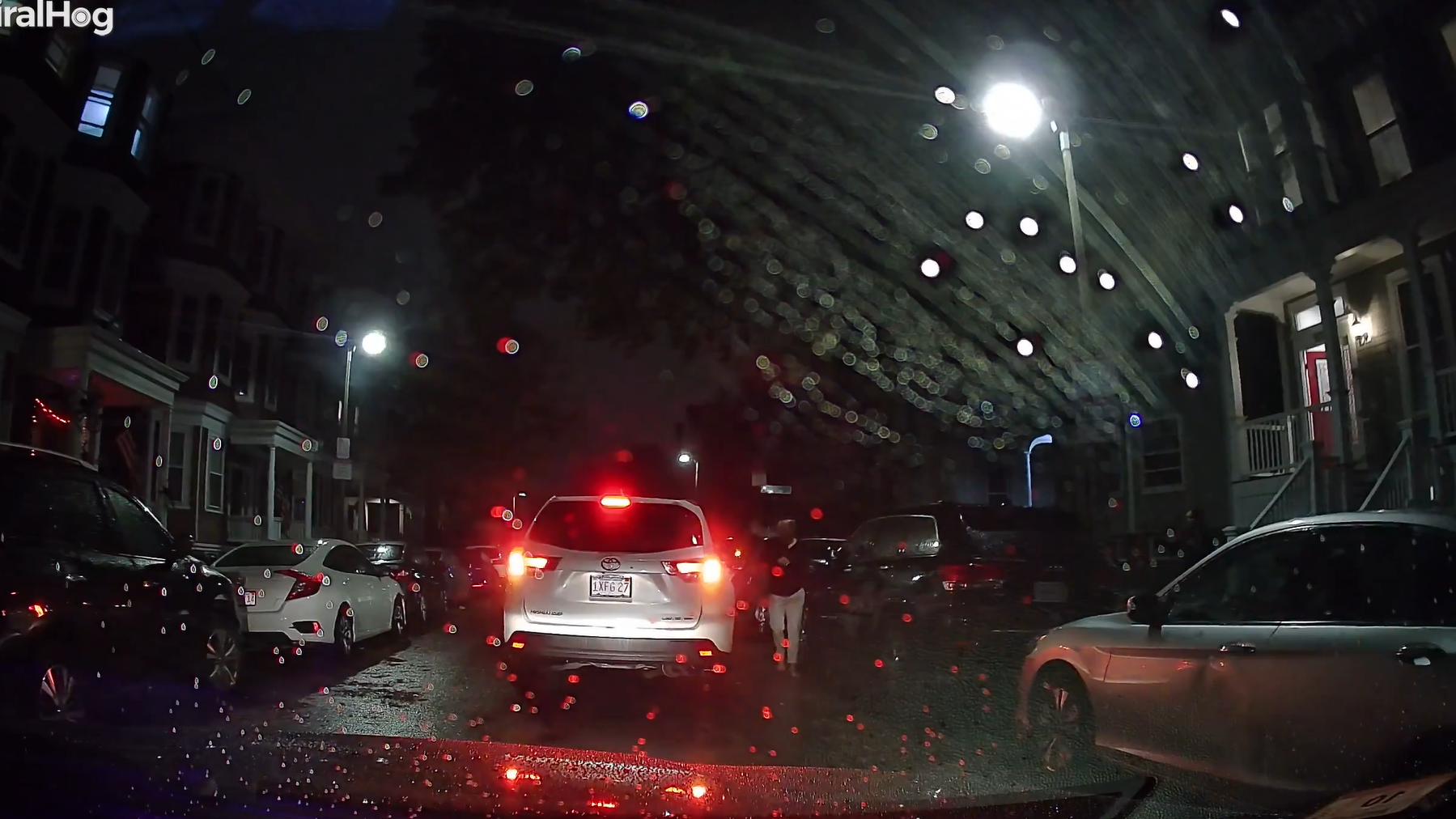 Watch a woman hang from a moving car door then lose her grip and fall ...