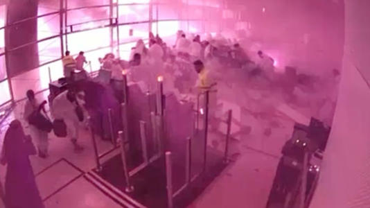 This image from CCTV video released by Saudi Arabia's Media Ministry shows passengers taking cover as flames and smoke fill part of King Khalid International Airport in Riyadh on Saturday. - Saudi Media Ministry/AP
