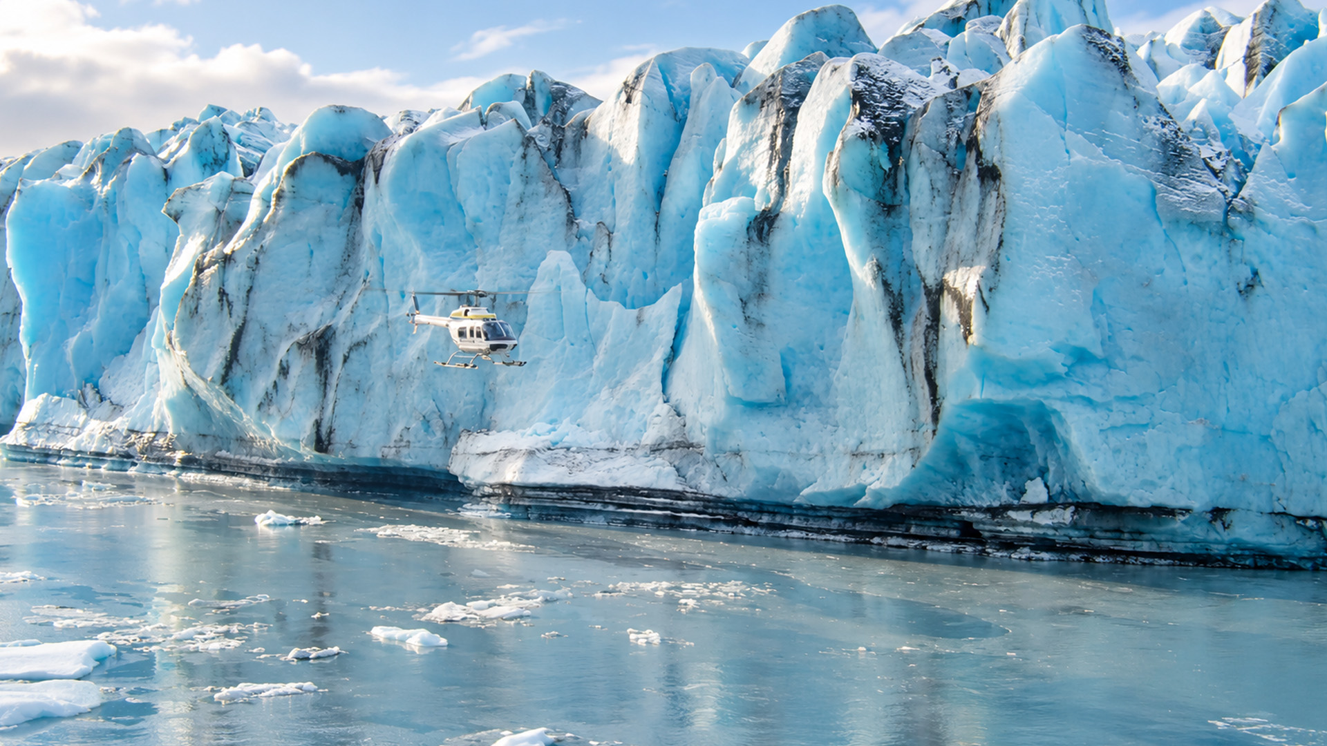A helicopter dwarfed by towering blue ice cliffs