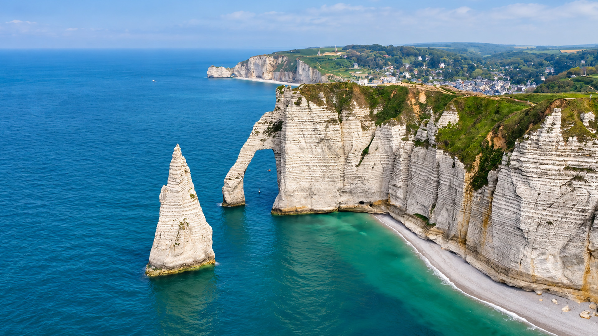 France's towering white cliffs beside turquoise water