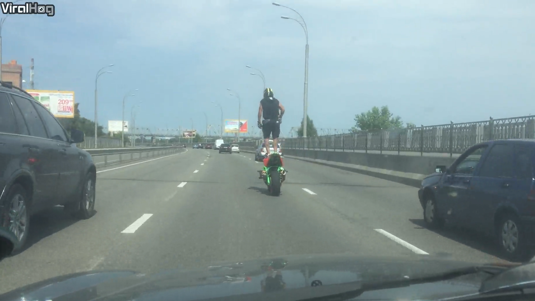 Watch the moment a man stands up on his motorcycle while riding through ...