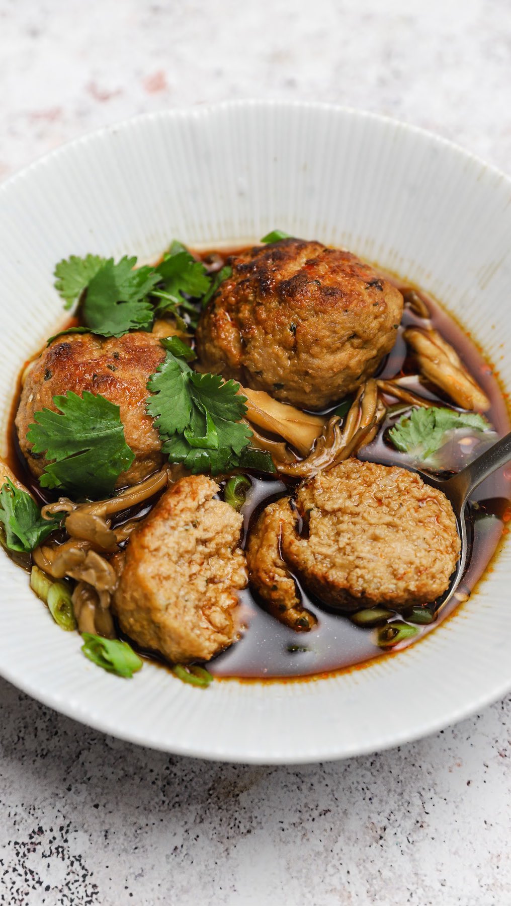 Juicy pork meatballs in ginger scallion broth