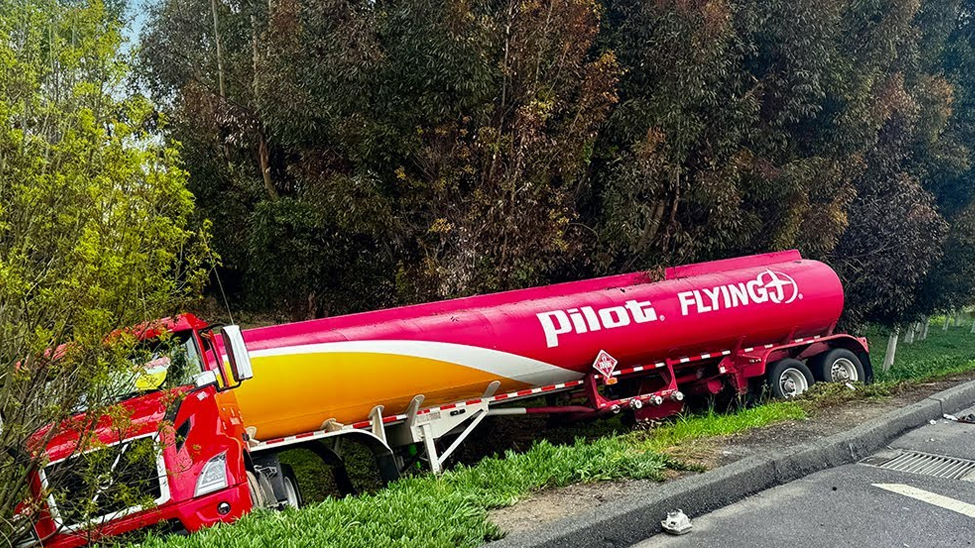 Fuel tanker leaves freeway and lands down embankment