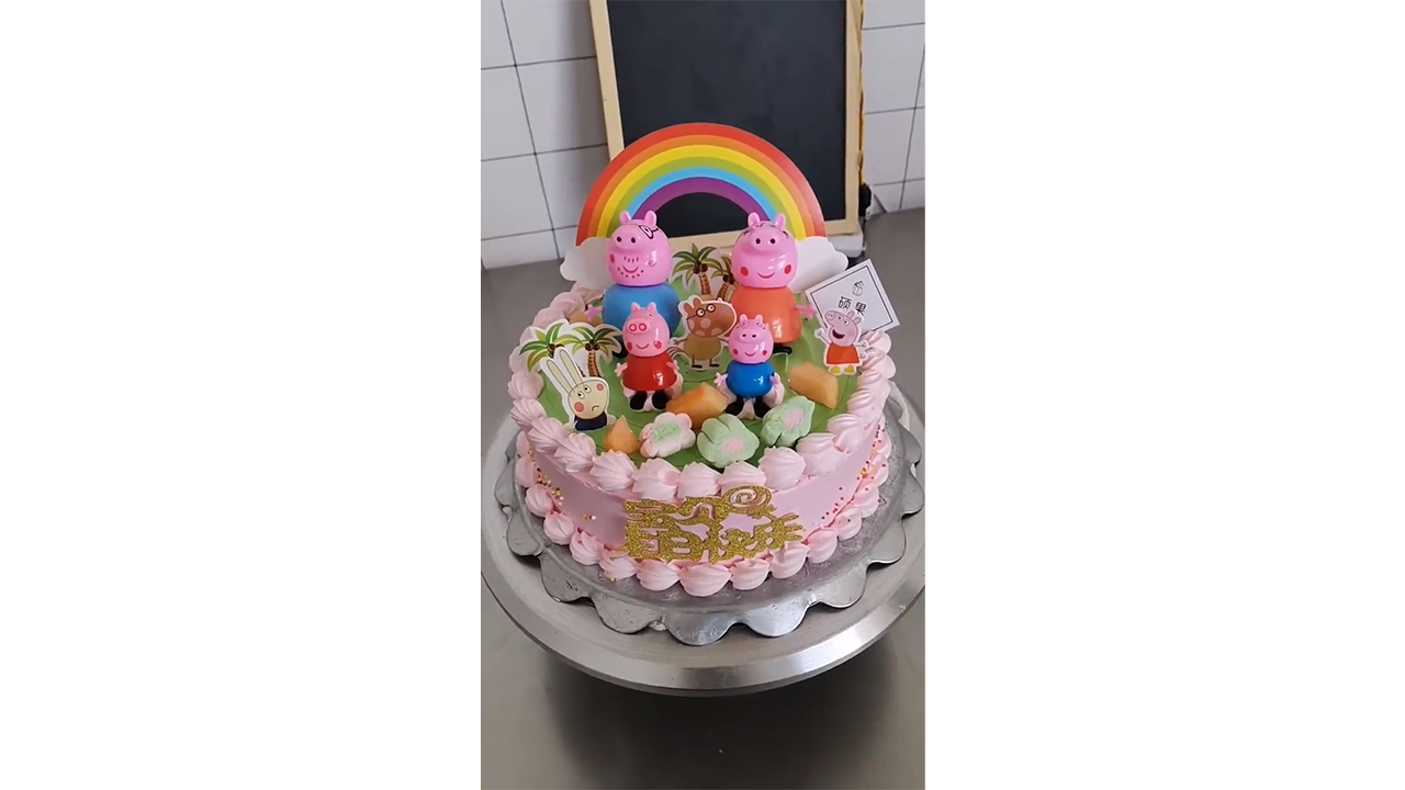 Decorating pink Peppa Pig cake with rainbow and pastel flowers
