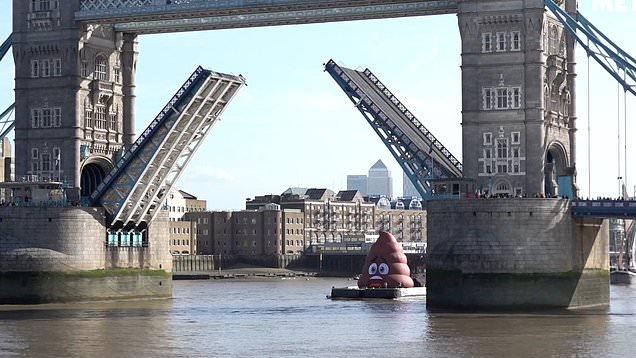 Danny Dyer sails giant pile of poo emoji inflatable on River Thames in ...