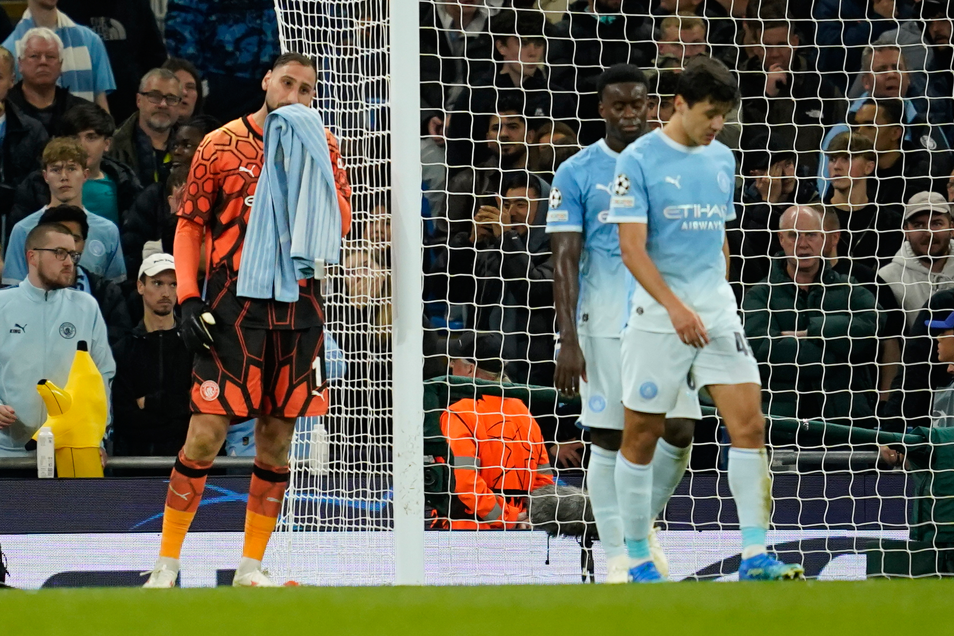 Manchester City's goalkeeper Gianluigi Donnarumma, left, reacts after PSG's Maghnes Akliouche scored their fourth goal during the Champions League opening phase soccer match between Manchester City and Paris Saint-Germain in Manchester, England, Wednesday, Oct. 14, 2026. (AP Photo/Dave Thompson)
