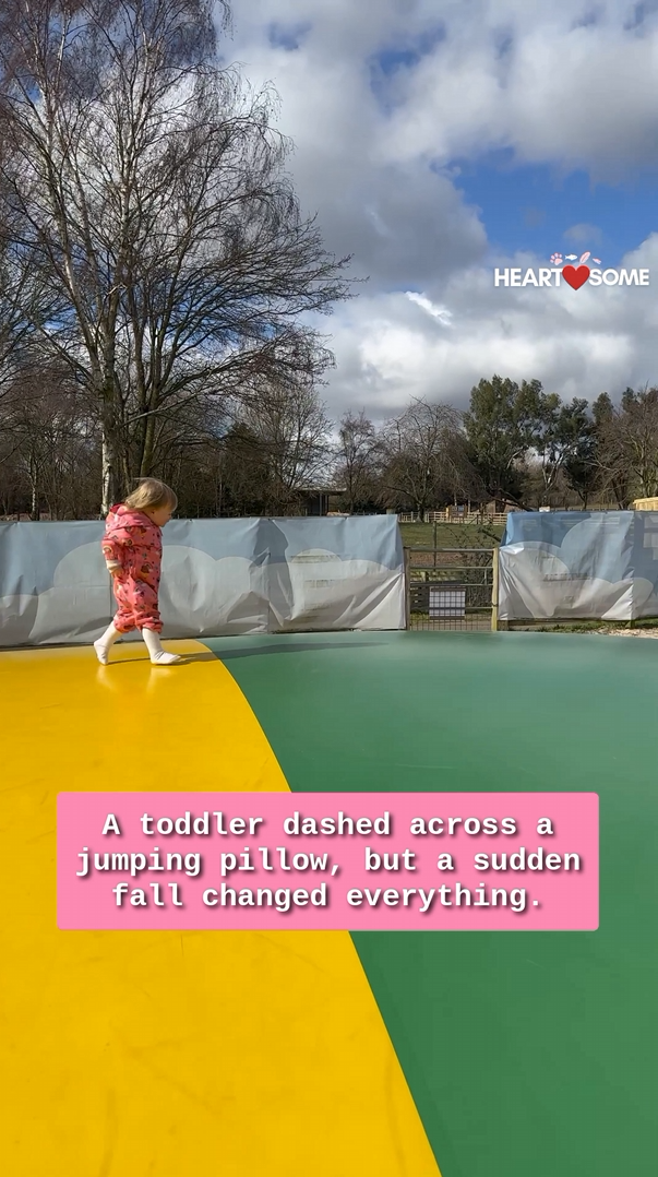 Young child joyfully leaps on inflatable cushion before unexpected plunge