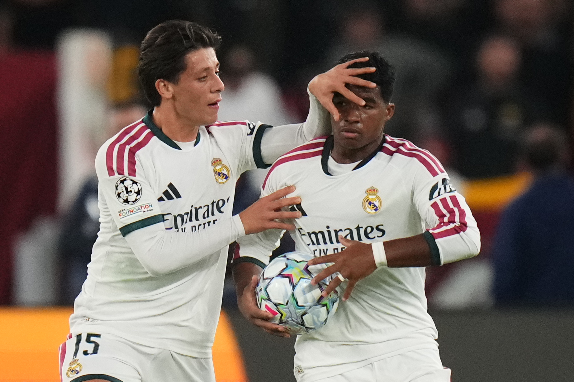 Real Madrid's Endrick celebrates with his teammate Arda Guler after scoring his side's third gola during a Champions League opening phase soccer match between Roma and Real Madrid, in Rome, Wednesday, Oct.14, 2026. (AP Photo/Alessandra Tarantino)