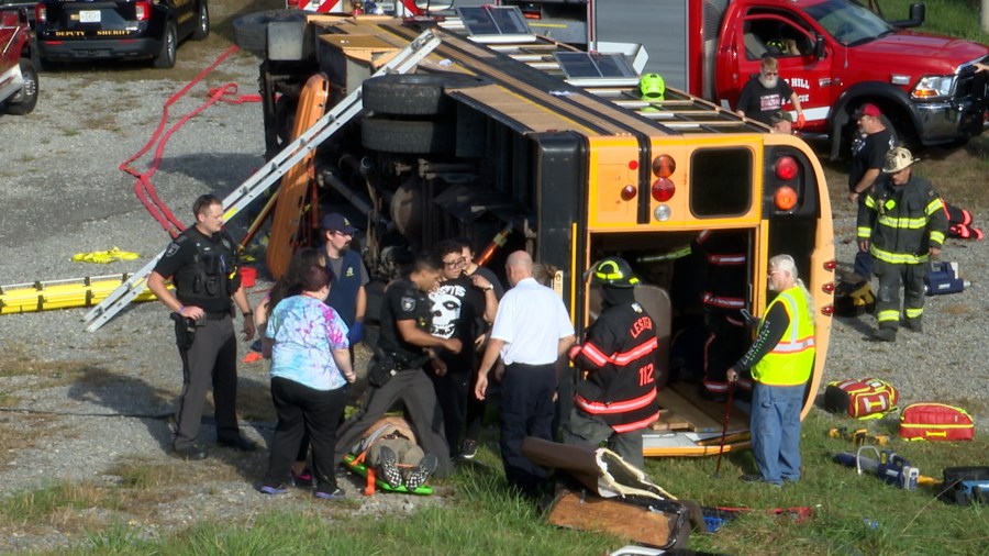 First responders and school officials simulate a bus rollover for a ...