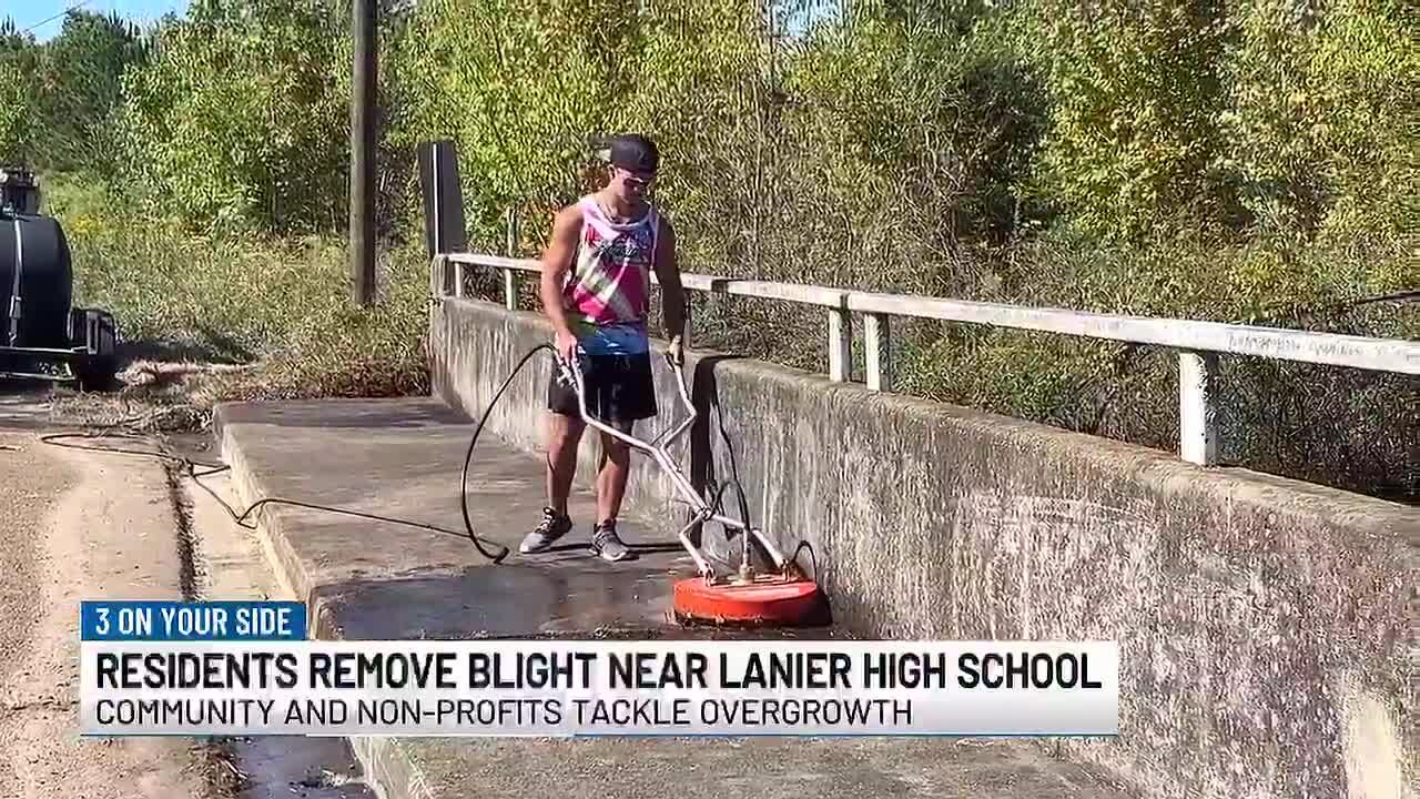 Residents and non-profits clear debris and pressure wash bridge near Lanier High School