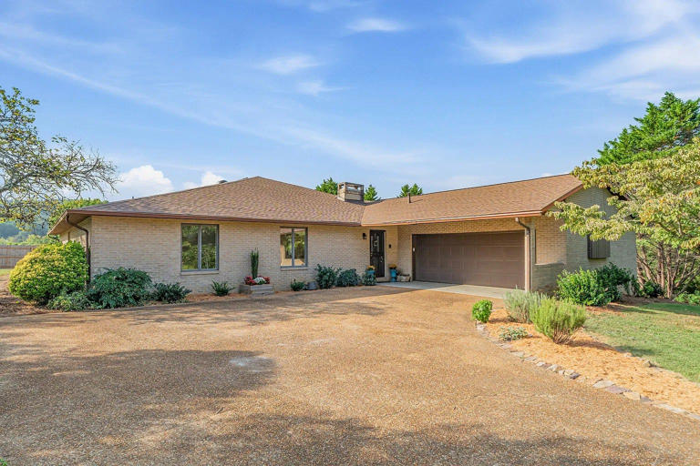 This house for sale in Halls is brick ranch in front, pool party inside