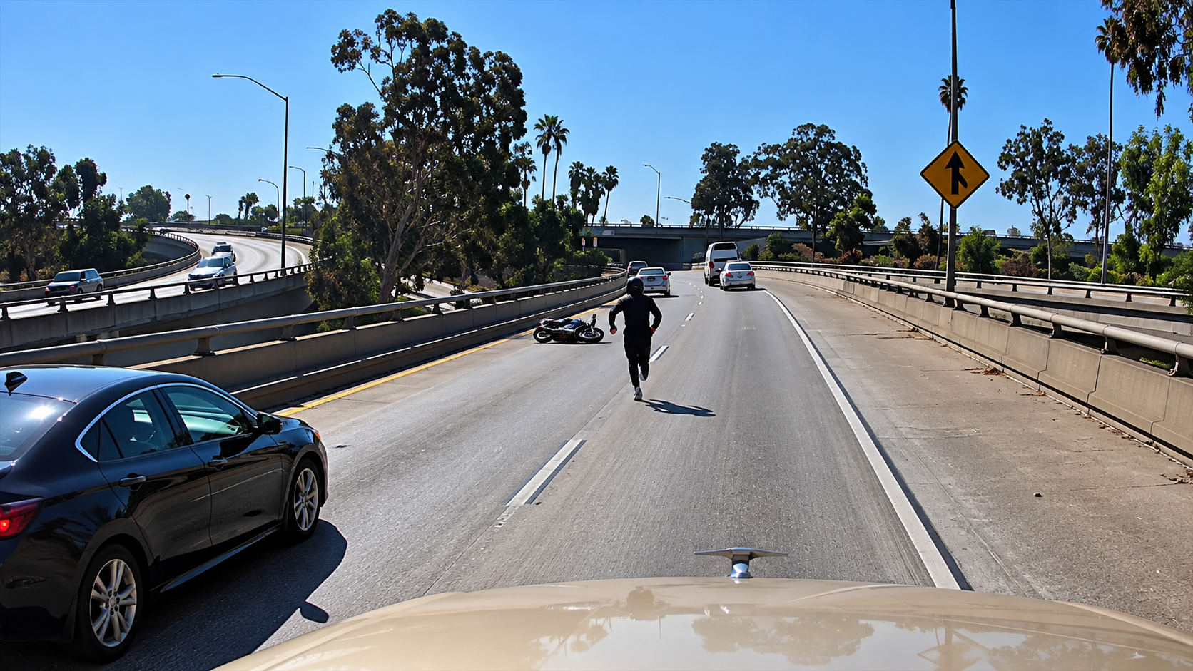 Watch the moment a biker follows too closely then falls under the car ahead
