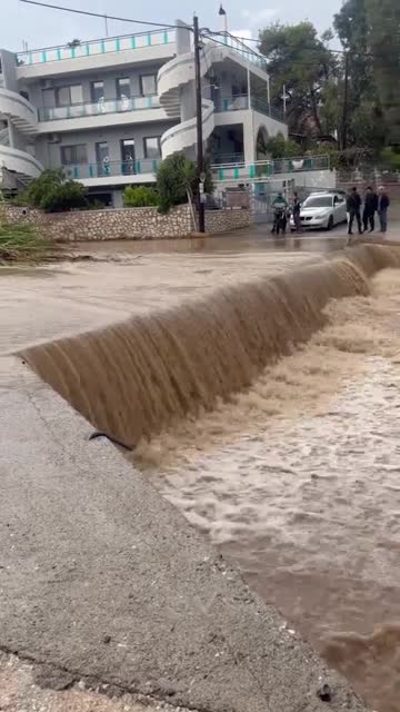 Cars engulfed by water as floods tear through Greek holiday island