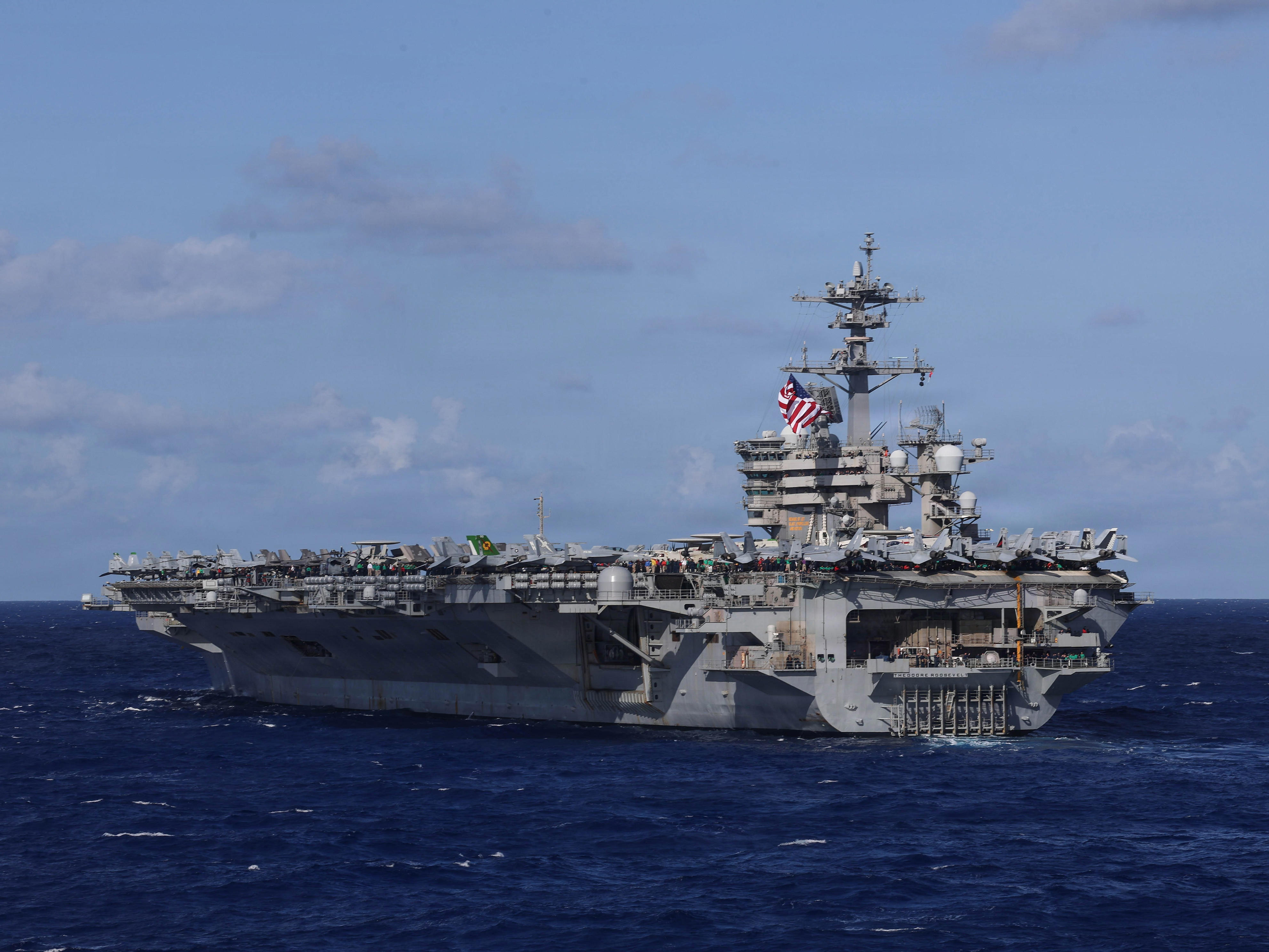 A US Navy carrier strike group just deployed with a big drone ship for ...