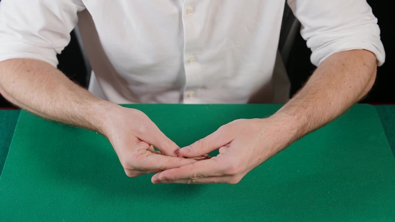 Oscar Owen teaches the coin-through-arm magic trick