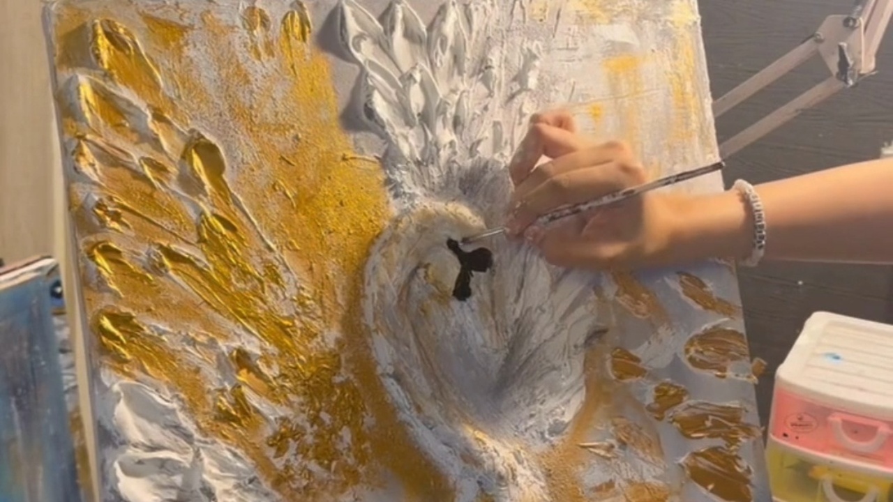 Artist paints a hyper-realistic swan on a canvas