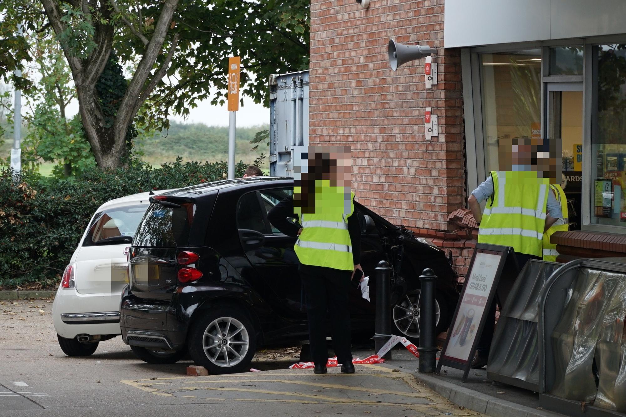 Photos show cordoned off cars and damaged wall after report of ...