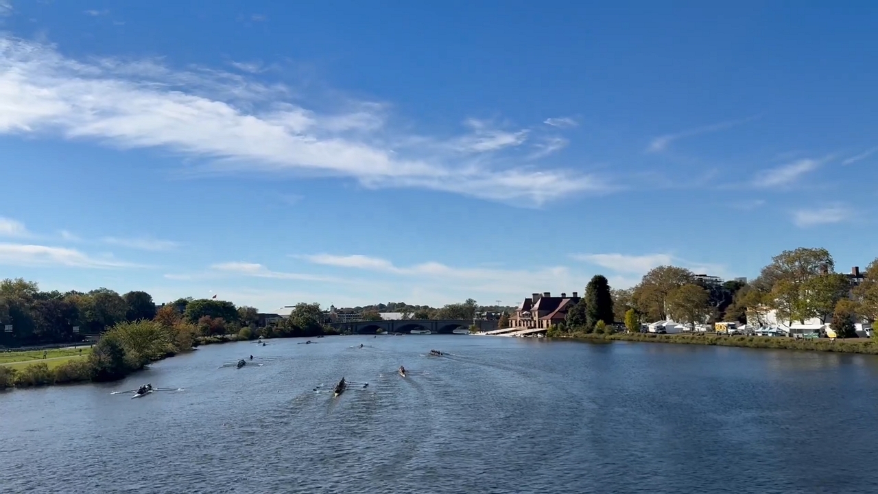Rowers navigate the scenic Charles River in Cambridge, Massachusetts