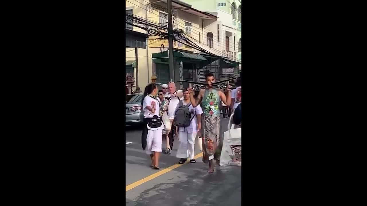 Devotees mutilate themselves in shocking vegetarian festival in Thailand
