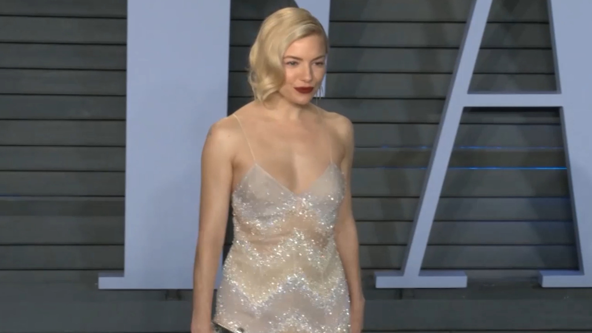 Sienna Miller shimmers in sheer sequin mini at Vanity Fair