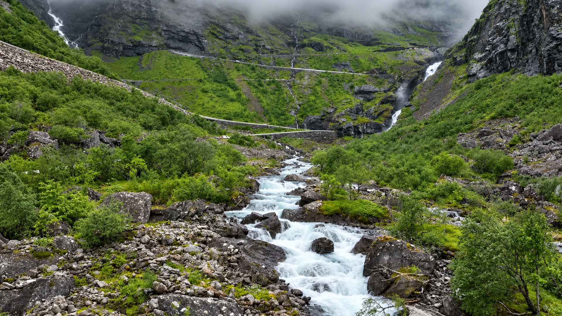 A rocky river flowing beneath Norway's mountain road