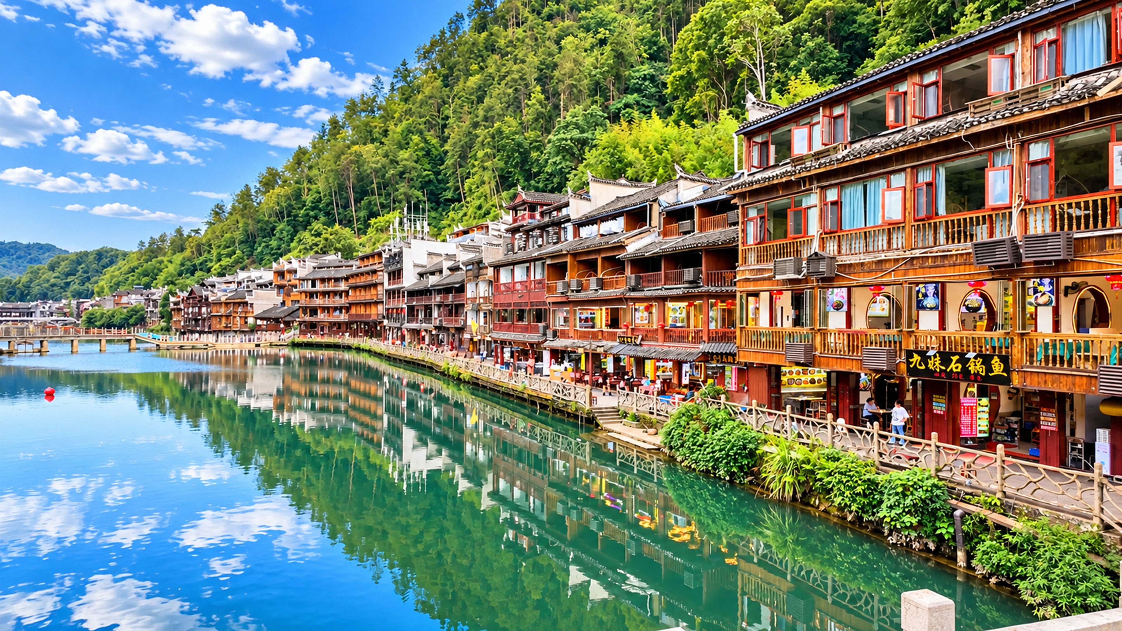 China’s wooden riverside buildings follow this emerald green river