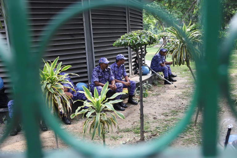 Security officres sit near the protest site ahead of a flag rally called by the Cockroach Janta Party (CJP), demanding the resignation of India's Chief Election Commissioner Gyanesh Kumar, in New Delhi, India, October 16, 2026. REUTERS/Bhawika Chhabra
