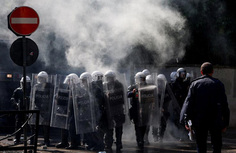 A protester faces off against police officers deploying anti-riot measures amid an anti-government protest by students in Tirana, Albania, October 16, 2026. REUTERS/Florion Goga