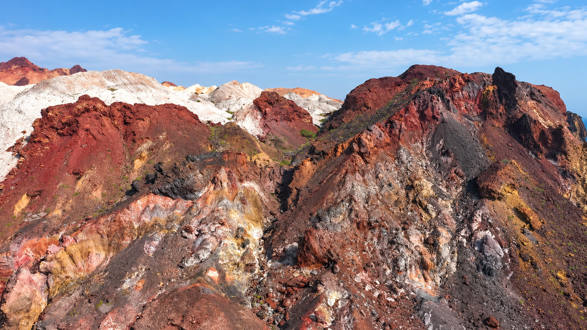 What makes these mountains look like painted rocks?