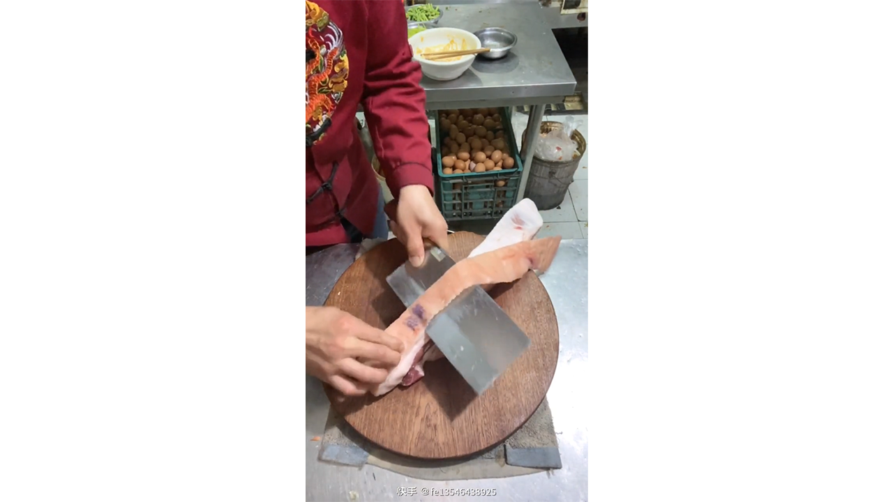 Cutting thick meat with two sharp cleavers creating clean and ...