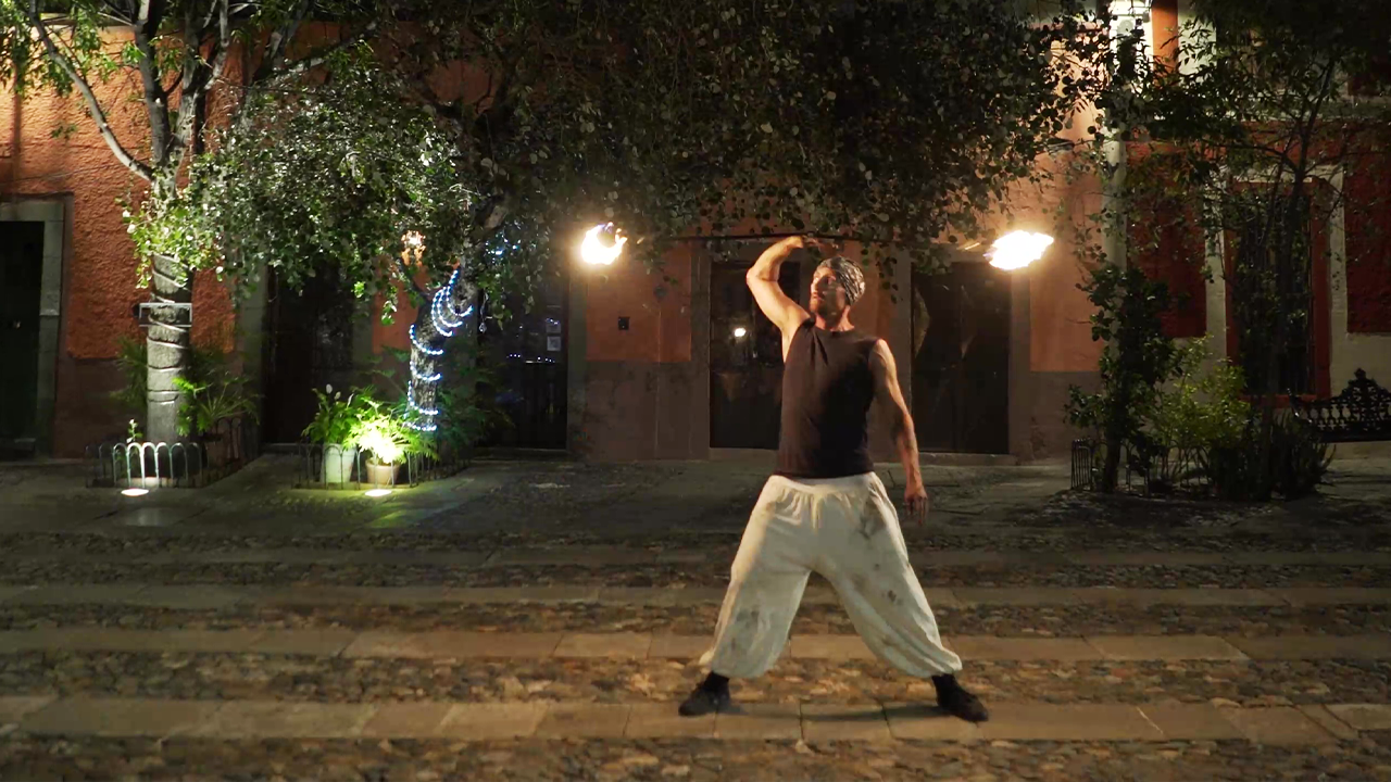 Fearless fire performer showcases smooth tricks while spinning a meteor ...