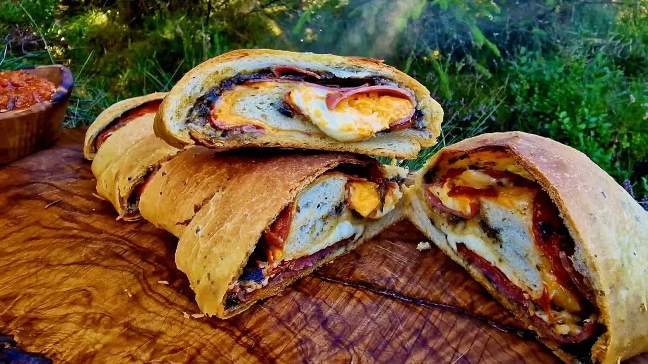Extra-crispy homemade stromboli cooked outdoors using bushcraft techniques