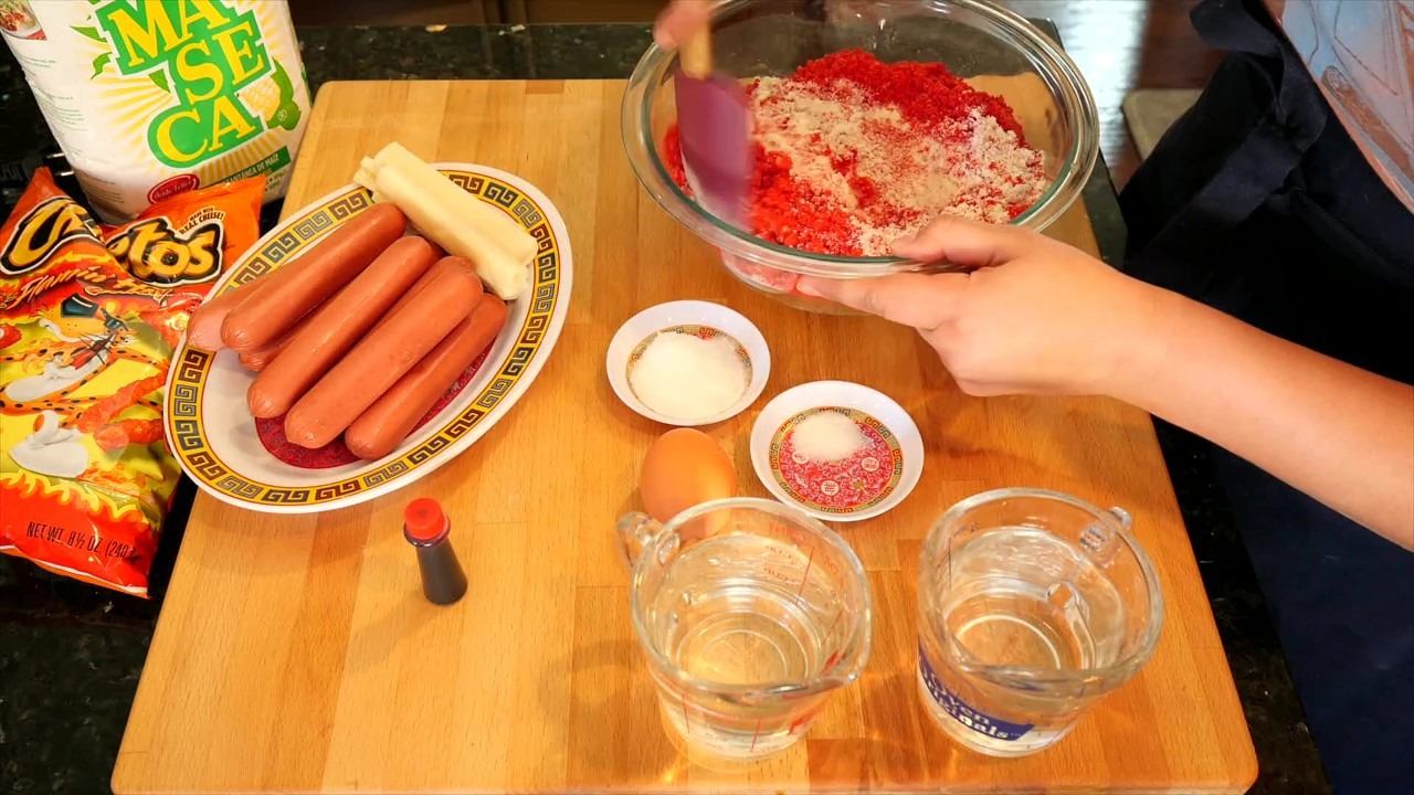 A cook makes Hot Cheetos Mexican corn dogs