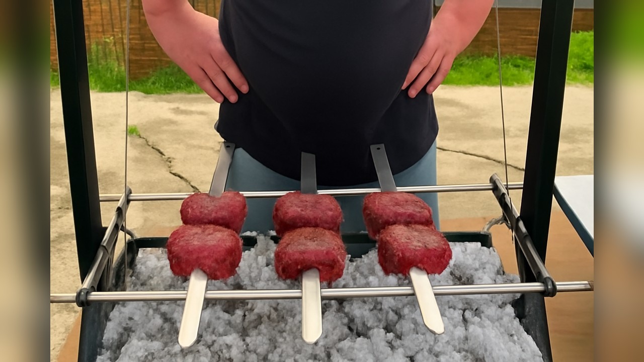 A pit cook grills teriyaki beef tenderloin swords