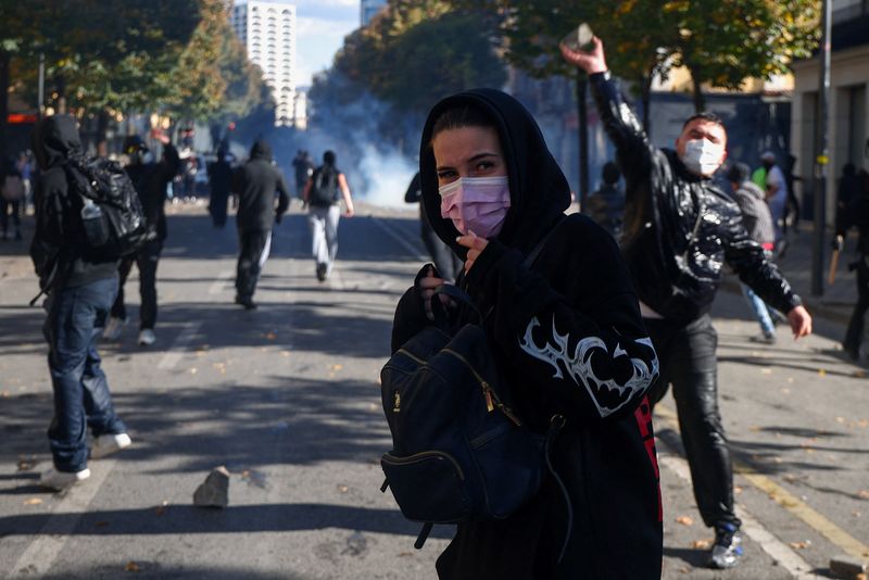 A demonstrator throws an object near another demonstrator, during an anti-government protest by students in Tirana, Albania, October 16, 2026. REUTERS/Florion Goga