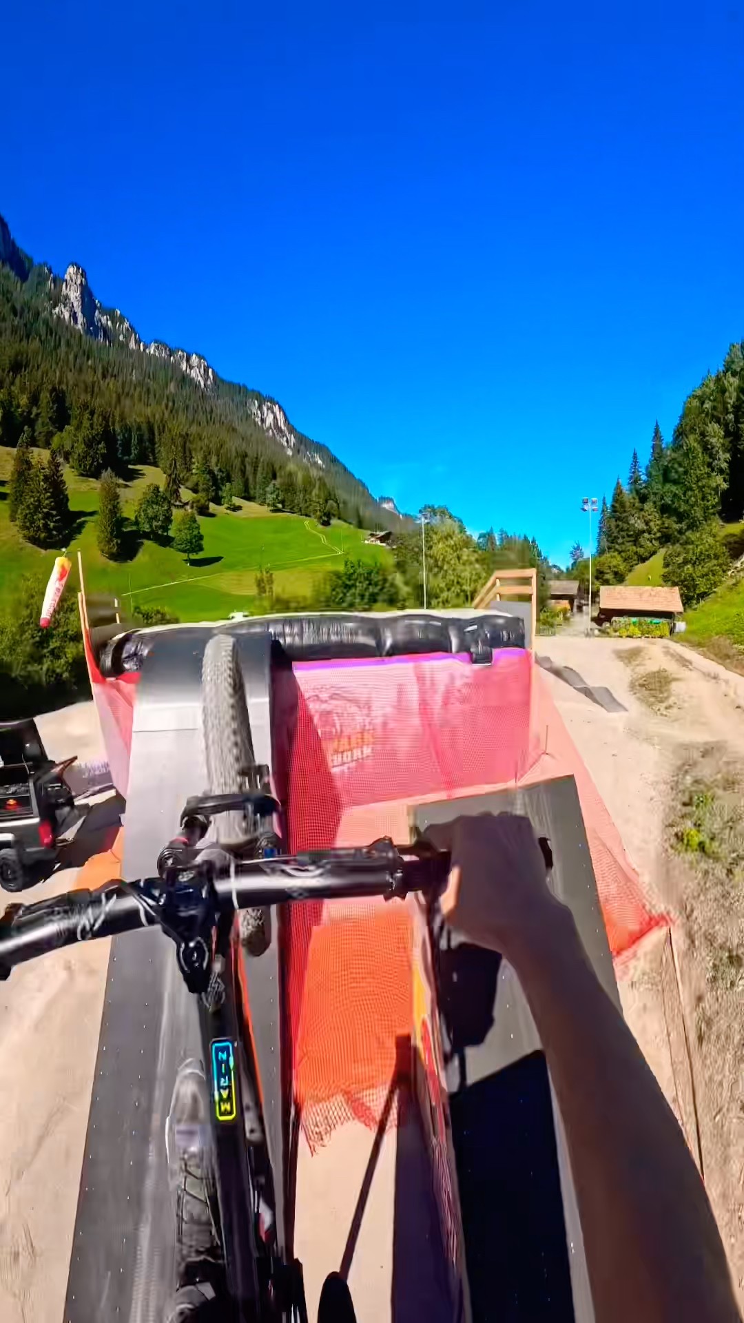 Riding down a giant mountain bike ramp into a massive public airbag