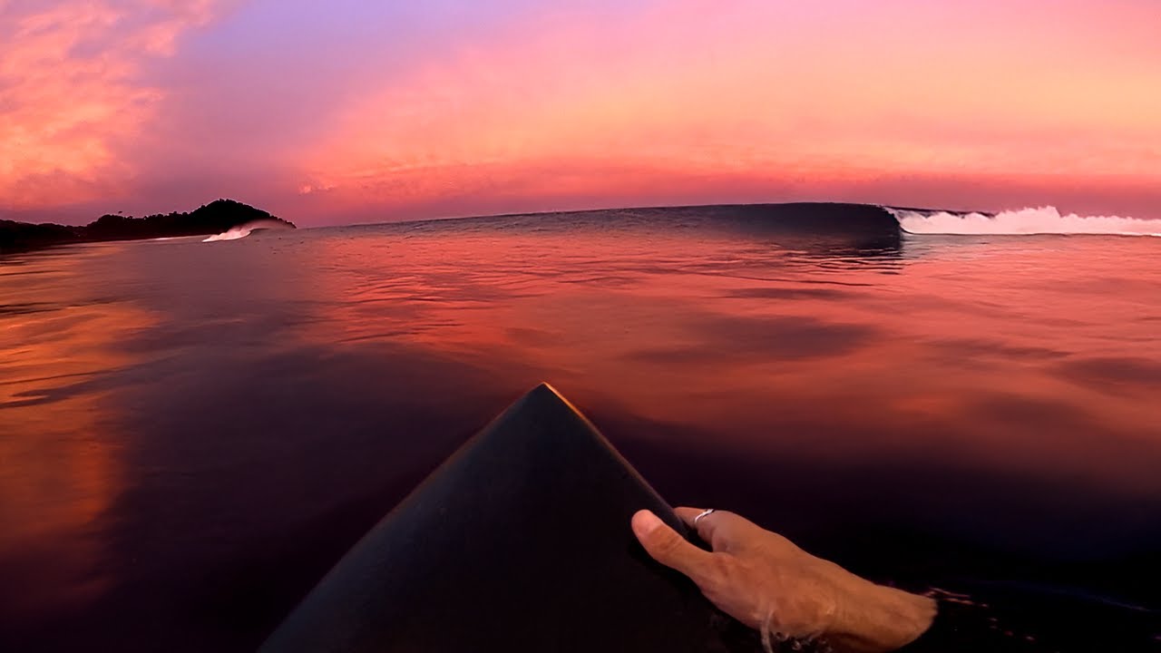 A surfer rides a new board from first drop to final wave at sunset