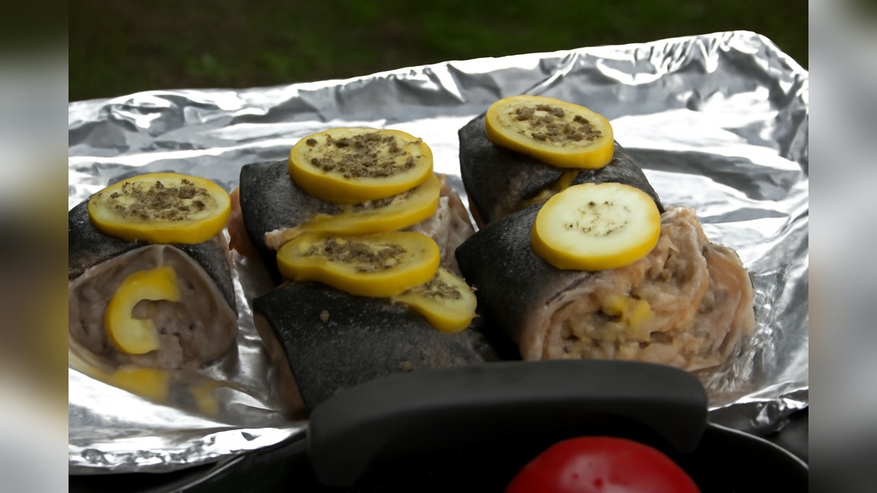 A cook stuffs a fish at the pit (part 3)