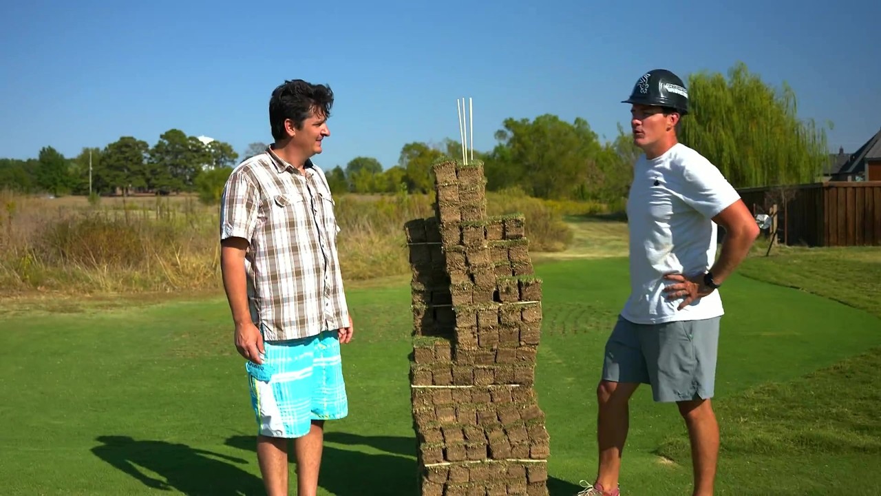 A crew builds a Sears Tower model with grass blocks