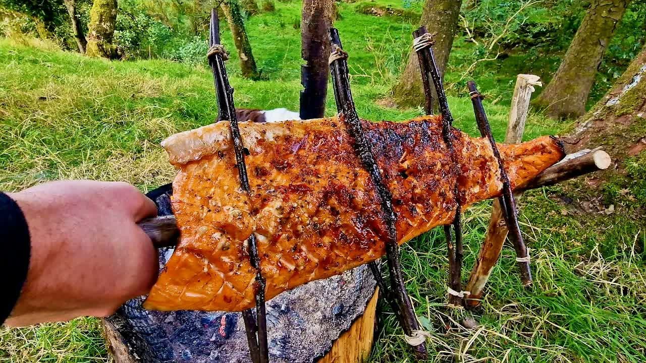 Fresh salmon cooked over a campfire using traditional bushcraft techniques