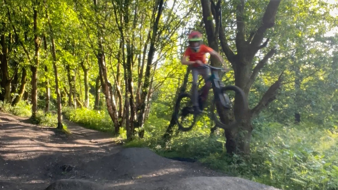 Cyclists navigate double jumps without falling