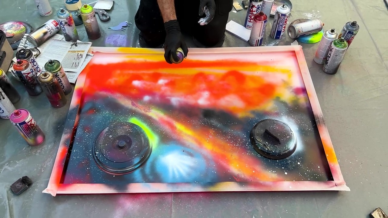 Street artist adds spray paint texture to a large painting