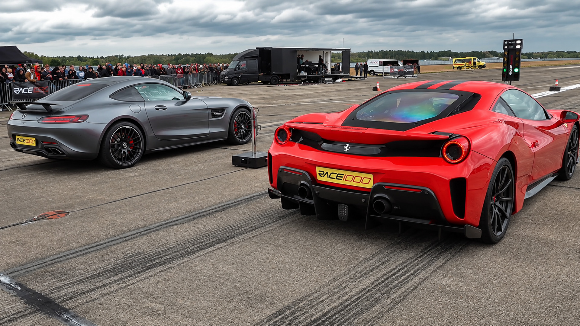 Two exotic performance cars explode off the line in a drag race