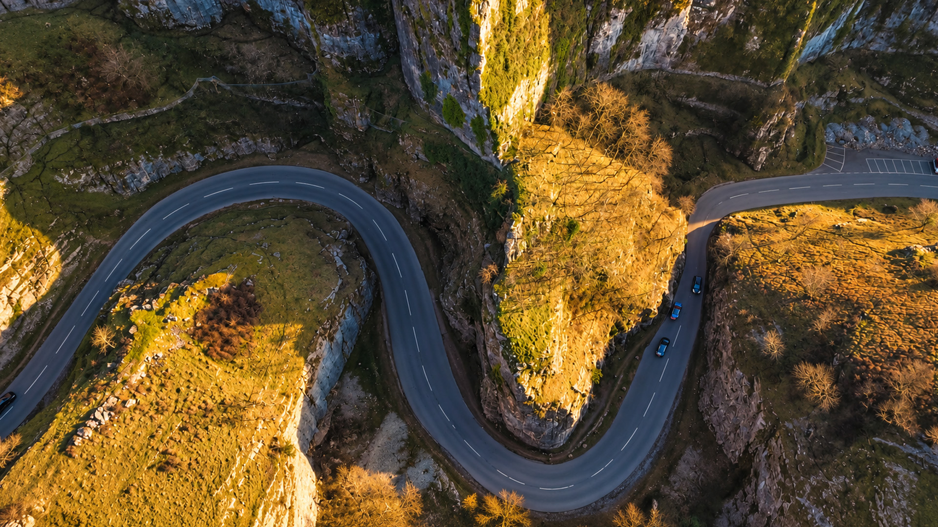 A winding road squeezed between towering rock walls