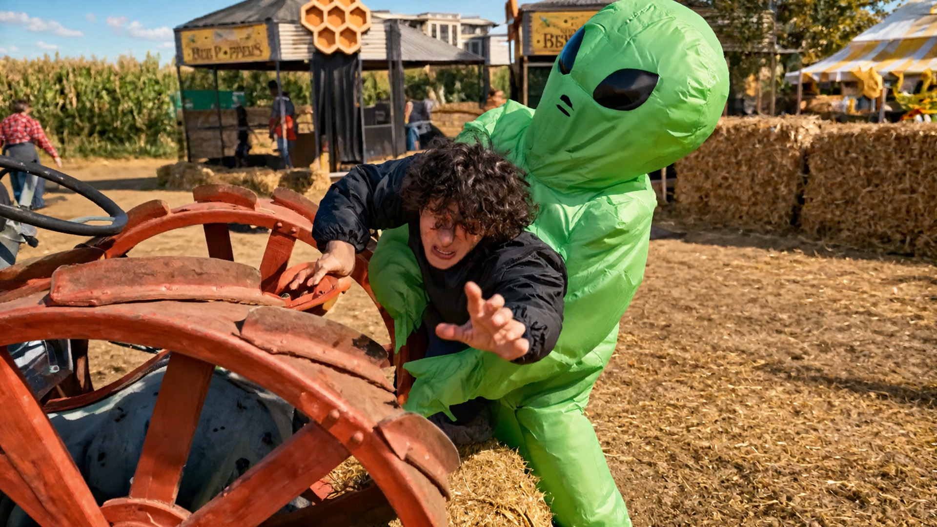 A green alien carries a human through a parkour chase