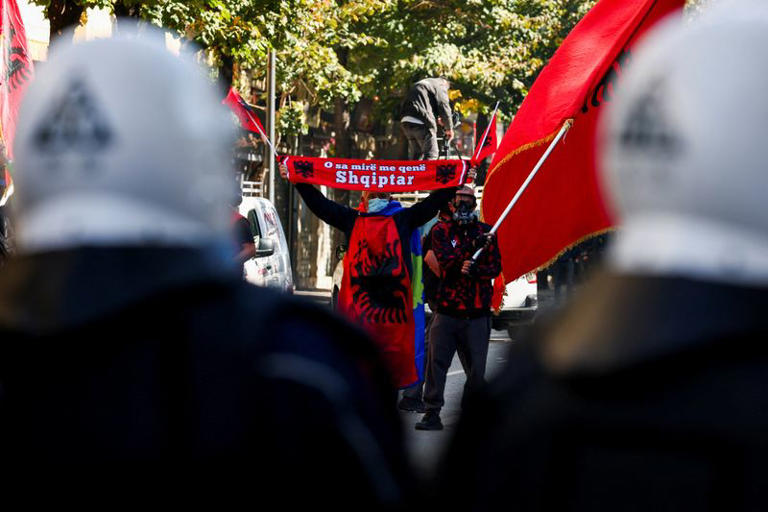 A protester holds a scarf reading: "Oh, how good it is to be Albanian", amid an anti-government protest by students in Tirana, Albania, October 17, 2026. REUTERS/Florion Goga