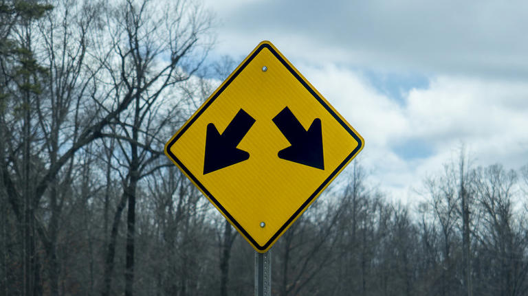 What to do when you see a yellow road sign with two arrows pointing down
