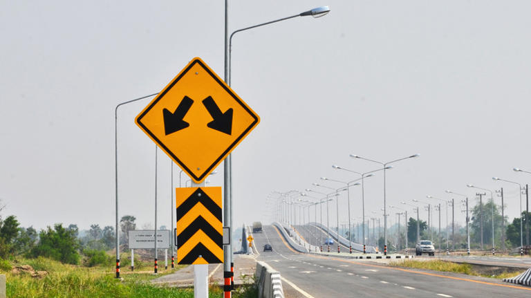What to do when you see a yellow road sign with two arrows pointing down