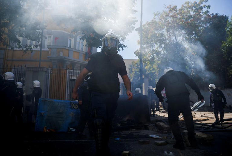 Riot police officers remove elements of a street baricade, amid an anti-government protest by students in Tirana, Albania, October 17, 2026. REUTERS/Florion Goga